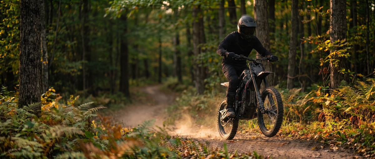 A rider on a Talaria Sting MX5 Pro on a forest trail