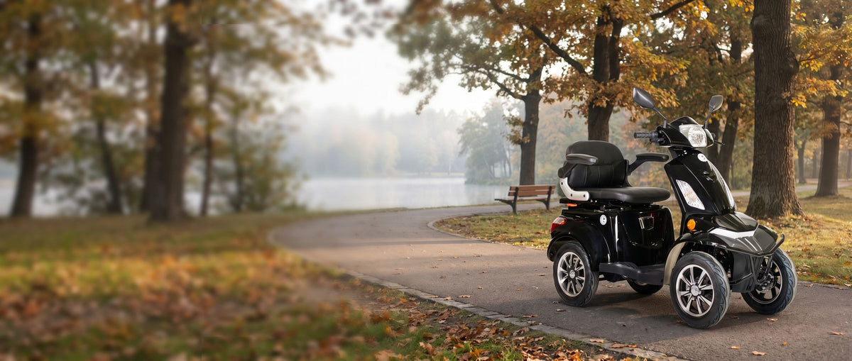 Eclipse EV Nebula mobility scooter on a lakeside park path in the fall